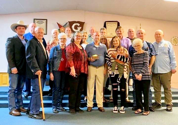 Brother Munkres, center with award in hand, and members of his family, friends, and members of the Lodge.